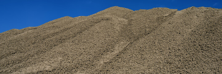clinker surface in a raw material warehouse and blue sky, cement production.