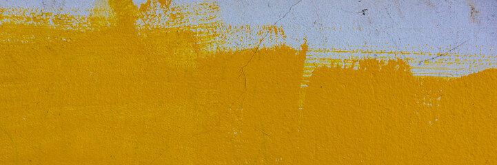 cement plaster covered with yellow paint, the surface of the wall.