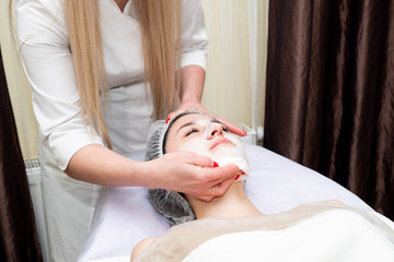 young woman in spa apply facial procedure