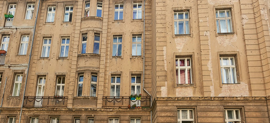 Berlin old building facade ridden with bullet holes, signs and scars of World War Two.