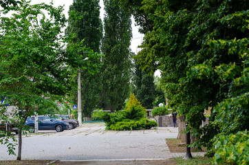 Parking in front of the hotel in one of the cities of Ukraine. Silence and peace in the middle of a cloudy summer day.