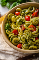 Homemade pasta with fresh basil pesto and tomatoes