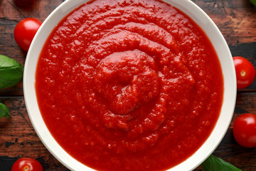 Homemade tomato Passata in white bowl on wooden table