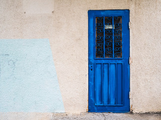 Old blue door. Metal door with carved figures