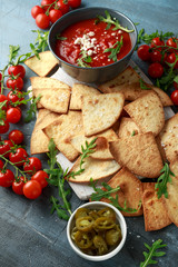 Grilled corn tortilla with sea salt flakes, spicy tomato salsa sauce and feta cheese