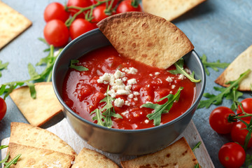 Grilled corn tortilla with sea salt flakes, spicy tomato salsa sauce and feta cheese
