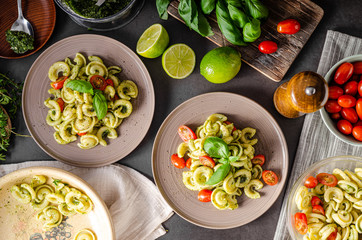 Fototapeta na wymiar Homemade pasta with fresh basil pesto and tomatoes