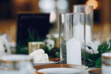 Beautiful white candles. Elegant wedding with white candles and flowers