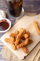 Hot and spicy Korean barbeque fried chicken on wood cutting board