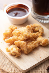 Hot and spicy Korean barbeque fried chicken on wood cutting board