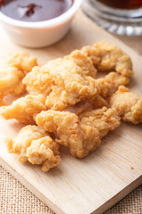 Hot and spicy Korean barbeque fried chicken on wood cutting board