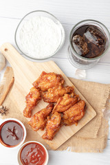 Hot and spicy Korean barbeque fried chicken on wood cutting board