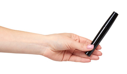 Hand with black mascara, eye makeup brush.