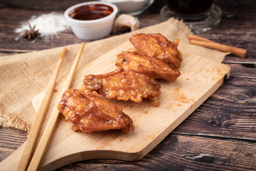 Hot and spicy Korean barbeque fried chicken on wood cutting board