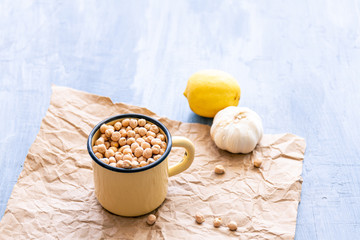 Metal enameled mug filled with hummus beans or chickpeas