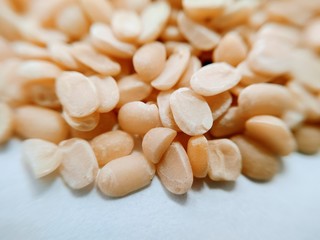 Extreme closeup on split black lentil without rind on white background