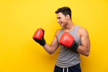 Handsome sport man over isolated background with boxing gloves
