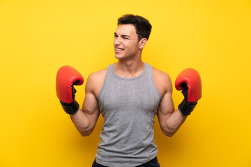 Handsome sport man over isolated background with boxing gloves