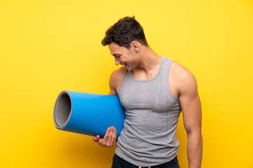 Handsome sport man over isolated background with mat