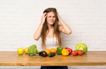 Young woman with many vegetables unhappy and frustrated with something. Negative facial expression