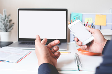 Young businessman working with smartphone and computer laptop on worktable.Connectivity and modern life concepts