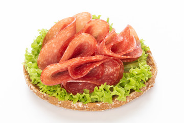 Sandwich with salami sausage on white background.