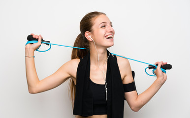 Young sport woman over isolated white background with jumping rope