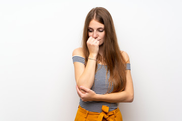 Young woman with long hair over isolated white wall having doubts