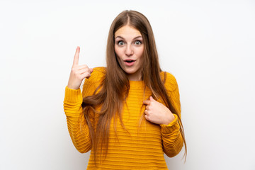 Young woman with yellow over isolated white wall with surprise facial expression
