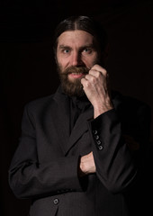 vintage handsome bearded man. severe man on a dark background. free space for your text
