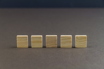 Five children wooden blocks in line, landscape, close up