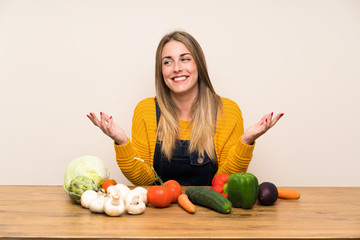 Fototapeta premium Woman with lots of vegetables laughing