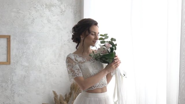 Bride Smelling Flowers In Wedding Bouquet
