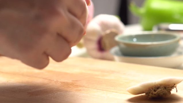 Preparing garlic on the wooden board top view