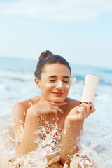 Suntan Lotion. Sexy Young Woman in Bikini  Applying Sunscreen Solar Cream.Sun Protection. Sun...