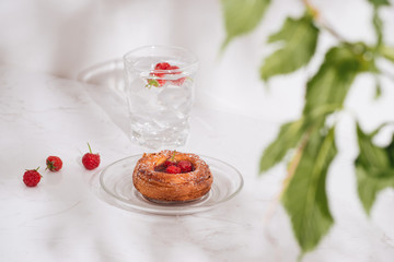 Sweet summer dessert, homemade puff pastry with berries , served with cold raspberry cider, fresh raspberries. On a white marble table, copy space top view