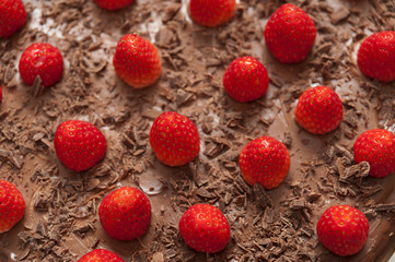 Delicious fresh strawberries on top of cake with chocolate icing. Top view. Close-up.