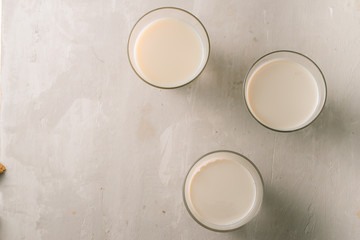 Obraz na płótnie Canvas Three glasses of milk on table. Top view.