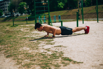 Athlete wearing black shorts making static exercise