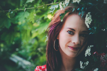 Attractive stylish young woman in a spring garden