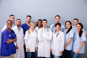 Portrait Of Medial Team Against Grey Background