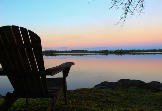 Adirondack chair facing sunset 