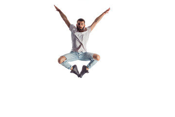 Male performer is doing breakdance, in front of a white wall