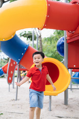children playing on playground in summer outdoor park
