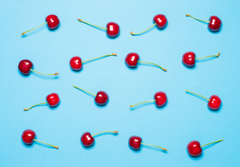 texture of red sweet cherry on a blue background