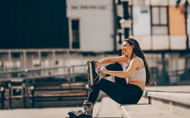 Teenage woman girl riding roller skates during summertime
