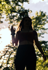 Happy girl dancing and listening to the music, low key, dark image
