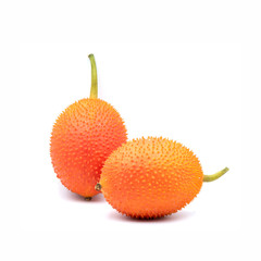 Momordica cochinchinensis fruit on white background.