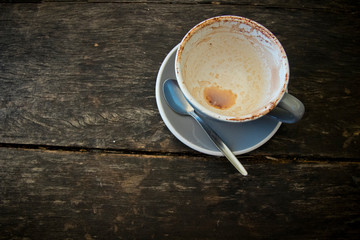 Empty coffee cup and saucer with teaspoon