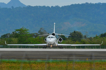 Passenger airplane taxiing on runway of airport